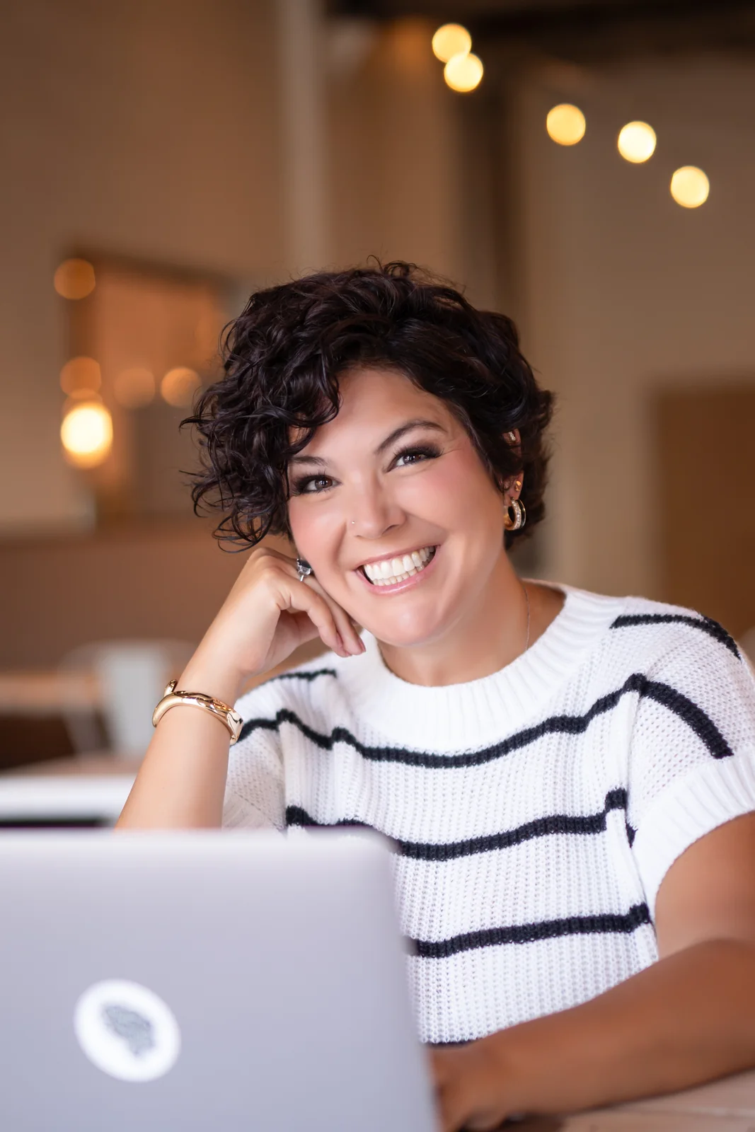 Jessica Doyle-Mekkes at a laptop, mid-session, smiling.