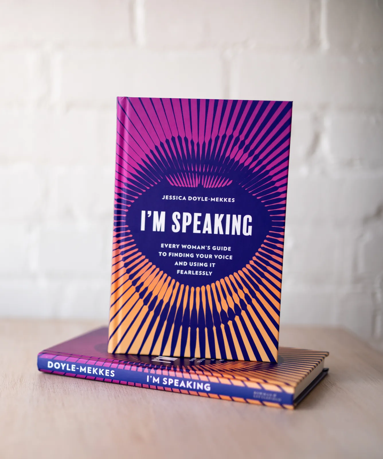 I'm Speaking by Jessica Doyle-Mekkes, resting on a stack of books.