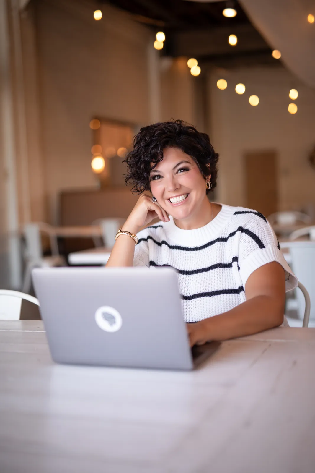 Jessica Doyle-Mekkes smiling at a laptop during an online voice lesson.