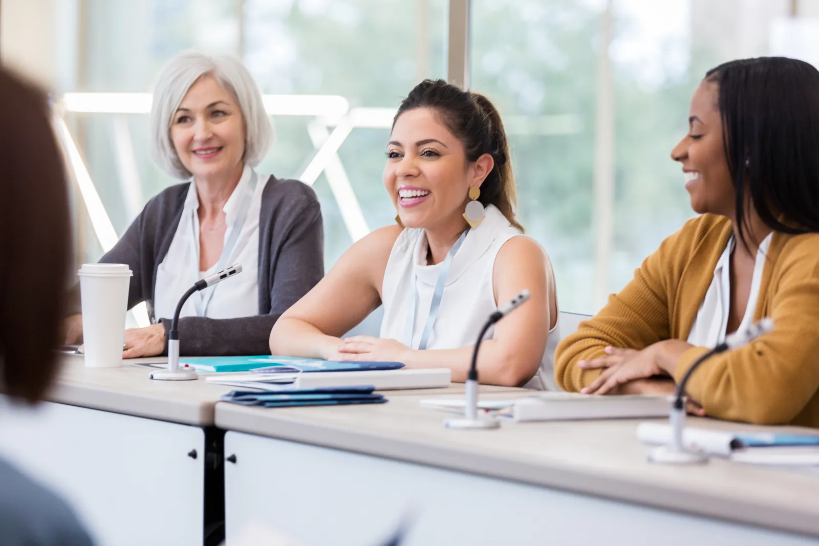 A small group seated around a table in an interactive workshop session.